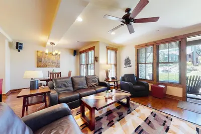 a living room with leather furniture and a ceiling fan at The Lodges 1145 in Mammoth Lakes