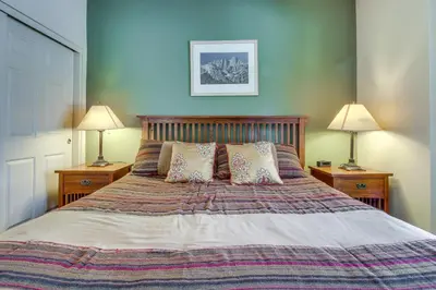 a bedroom with a large bed with two lamps at Mammoth Green 101 in Mammoth Lakes