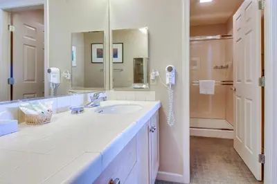 a white bathroom with a sink and a shower at Mammoth Green 101 in Mammoth Lakes