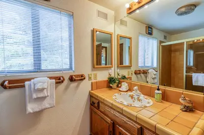 a bathroom with a sink and a mirror at Snowflower 54 in Mammoth Lakes
