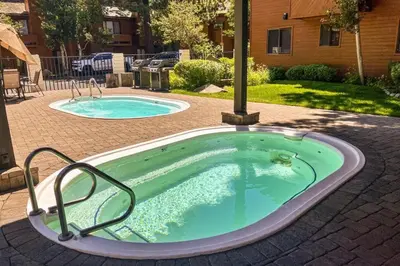 a jacuzzi tub in a yard at Snowflower 54 in Mammoth Lakes