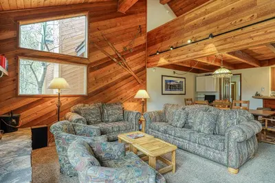 a living room with two couches and a table at Snowflower 54 in Mammoth Lakes