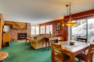 a living room with a table and a couch at Sierra Megeve 9 in Mammoth Lakes