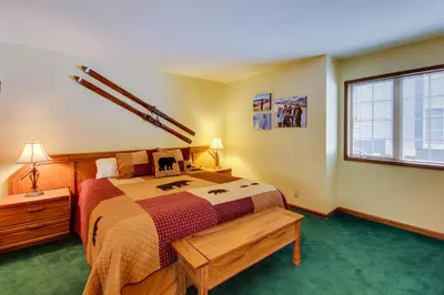 a bedroom with a large bed and a window at Sierra Megeve 9 in Mammoth Lakes