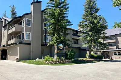 a building with two trees in front of it at Sierra Megeve 9 in Mammoth Lakes