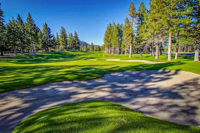 a view of a golf course with a green at The Bridges 23 in Mammoth Lakes