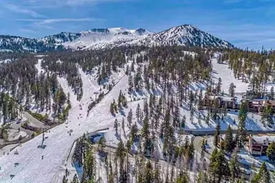 an aerial view of a ski resort in the snow at The Bridges 23 in Mammoth Lakes