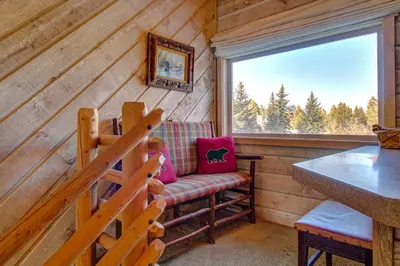 a room with a bench and a window in a cabin at Snowcreek 233 in Mammoth Lakes