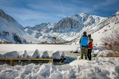 a man and a woman standing in the snow at Snowcreek 233 in Mammoth Lakes