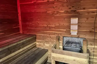 a wooden room with two benches in a sauna at Timberline 35 in Mammoth Lakes