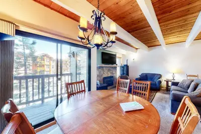 a dining room with a table and a living room at Val D'Isere 26 in Mammoth Lakes