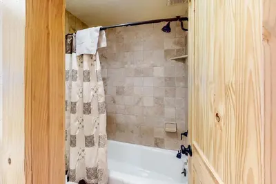 a bathroom with a tub and a shower curtain at Val D'Isere 26 in Mammoth Lakes