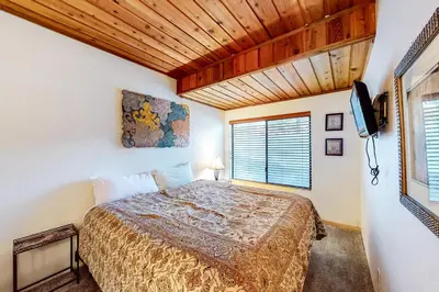 a bedroom with a bed and a television in it at Val D'Isere 26 in Mammoth Lakes