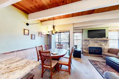 a dining room with a table and chairs and a fireplace at Val D'Isere 26 in Mammoth Lakes