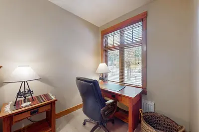 an office with a desk and a chair and a window at Lodestar Cabins in Mammoth Lakes