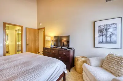 a bedroom with a bed and a couch and a television at Snowcreek 590 in Mammoth Lakes