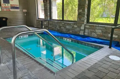 a swimming pool with a stairway leading into a house at Snowcreek 590 in Mammoth Lakes