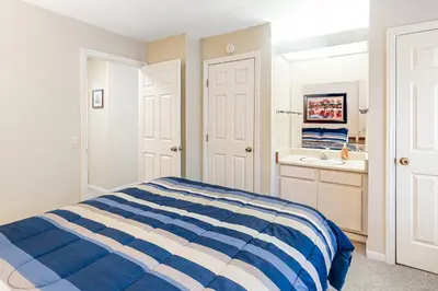 a bedroom with a blue and white bed and a sink at The Summit 207 in Old Mammoth