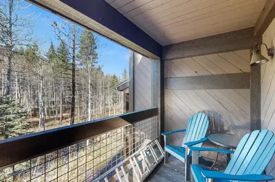 two chairs and a table on a porch with a view at Great Northstar Condo in Kingswood Estates