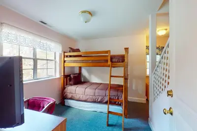 a bedroom with a bunk bed and a tv at Great Escape Cabin (08/253) in Groveland
