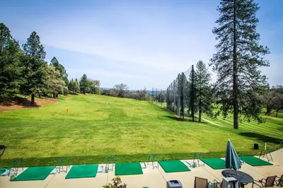 a view of a golf course with a green field at Mule Deer Cabin (4-538) in Groveland