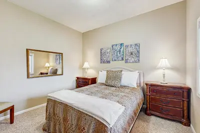 a bedroom with a bed and two night stands and a mirror at Mule Deer Cabin (4-538) in Groveland