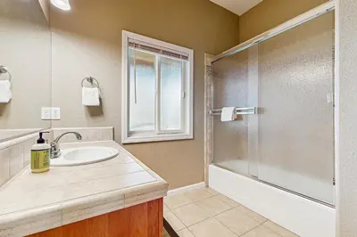 a bathroom with a sink and a shower at Mule Deer Cabin (4-538) in Groveland