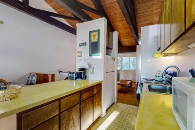 a kitchen with wooden cabinets and a white refrigerator at Dollar Hill 2 Dreamcatcher in Dollar Point