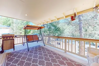 a screened in porch with a swing and a table at Owl's Lookout (05/061) in Groveland
