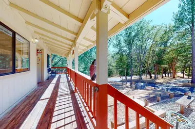 a porch of a house with a red railing at Owl's Lookout (05/061) in Groveland