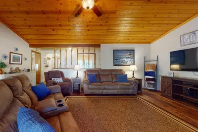 a living room with couches and a flat screen tv at Owl's Lookout (05/061) in Groveland