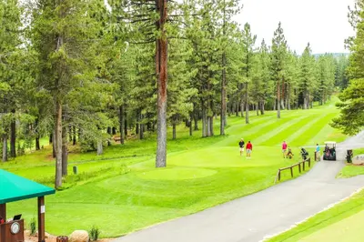 a group of people playing golf on a golf course at Northstar Ski Trails in Truckee