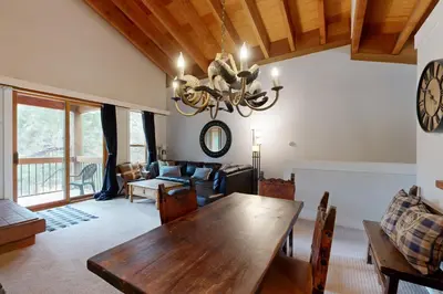 a dining room with a wooden table and a couch at Gold Bend 5034 in Truckee
