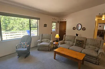 a living room with couches and chairs and a table at Forest Treasure (01/497) in Groveland