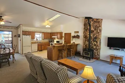 a living room with a table and a kitchen at Forest Treasure (01/497) in Groveland