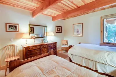 a bedroom with two beds and a dresser with a mirror at 1225 Gold Bend in Truckee