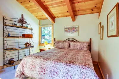 a bedroom with a bed and a wooden ceiling at 1225 Gold Bend in Truckee