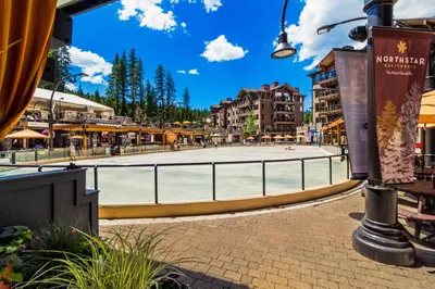 a street in a town with a basketball court at Aspen Grove Studio at Northstar in Truckee