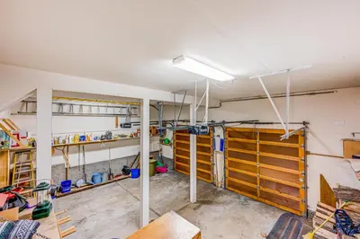 a garage with wooden doors and shelves in it at Ford Family Escape in Truckee