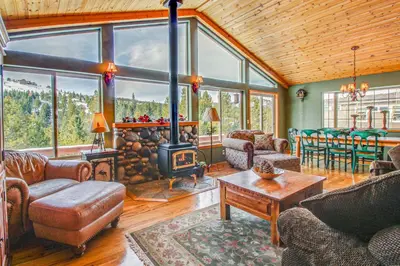 a living room with a wood burning stove in a house at Hillside View Vacation Home in Truckee