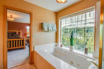 a bathroom with a large tub and a window at Hillside View Vacation Home in Truckee