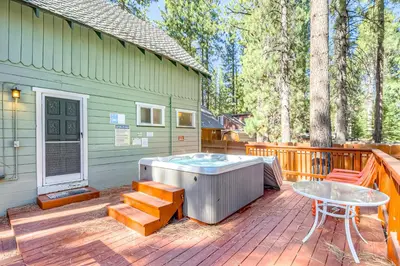 a hot tub on a deck next to a house at Foxglove Terrace in South Lake Tahoe