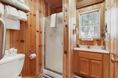 a bathroom with a shower and a toilet and a sink at Cozy Bobby Grey Manor in South Lake Tahoe