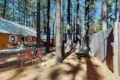 a group of chairs sitting in front of a cabin at Cozy Bobby Grey Manor in South Lake Tahoe