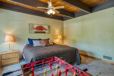a bedroom with a bed and a pool table at Tahoe Keys Waterfront with Dock in South Lake Tahoe