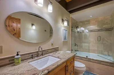 a bathroom with a sink and a toilet and a mirror at Tahoe Keys Waterfront with Dock in South Lake Tahoe