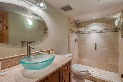a bathroom with a glass bowl sink and a shower at Tahoe Keys Waterfront with Dock in South Lake Tahoe