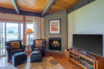a living room with a flat screen tv and a fireplace at Tahoe Keys Waterfront with Dock in South Lake Tahoe