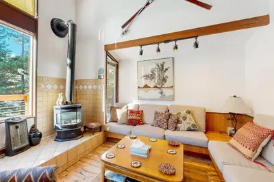 a living room with a couch and a stove at Squaw Valley Views Condo #15 in Olympic Valley
