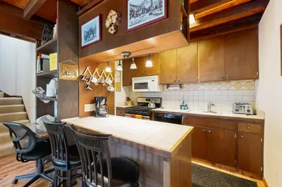 a kitchen with wooden cabinets and a counter top at Squaw Valley Views Condo #15 in Olympic Valley